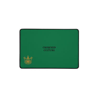 Green CBC desk mat with black text and a gold crown shown on a white background.