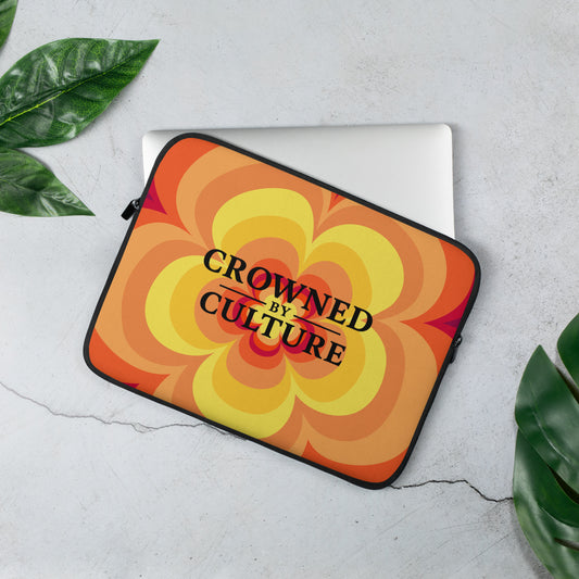 Laptop sleeve featuring bold patterned design and centered Crowned By Culture logo.