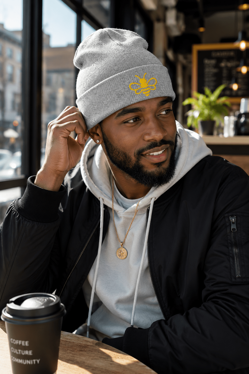 MHA Signature Beanie featuring the embroidered Melanin & Honey bee logo in a premium lifestyle setting.